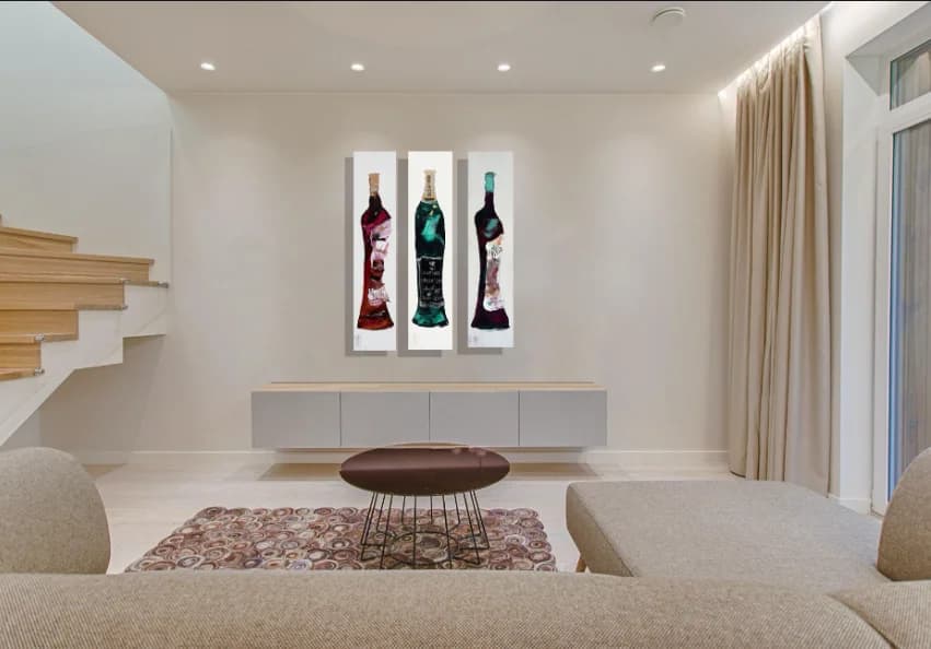 Trio of bottles: three tall wine bottle paintings in burgundy, emerald, plum on white panels. Original painting by Kim Kennedy.
