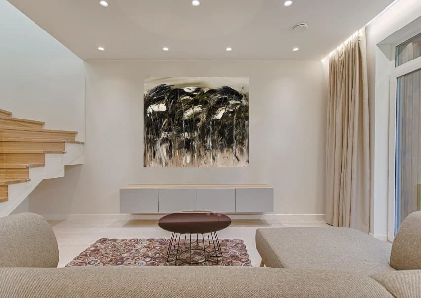 Wild Trees: black and cream gestural windswept trees painting hung in styled lounge. Original painting by Kim Kennedy.